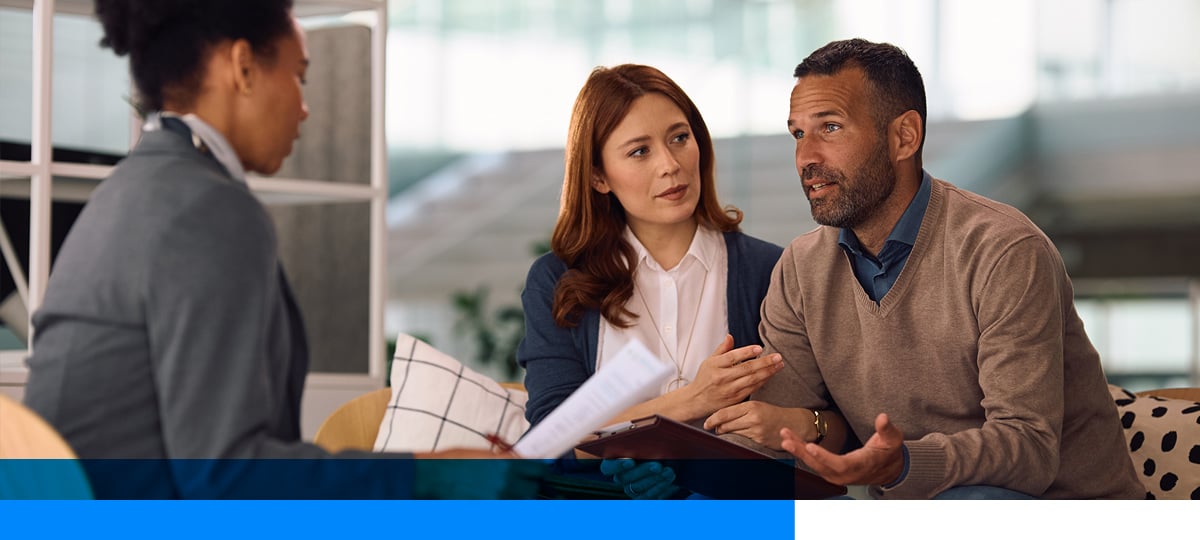 Couple meeting with life insurance advisor.