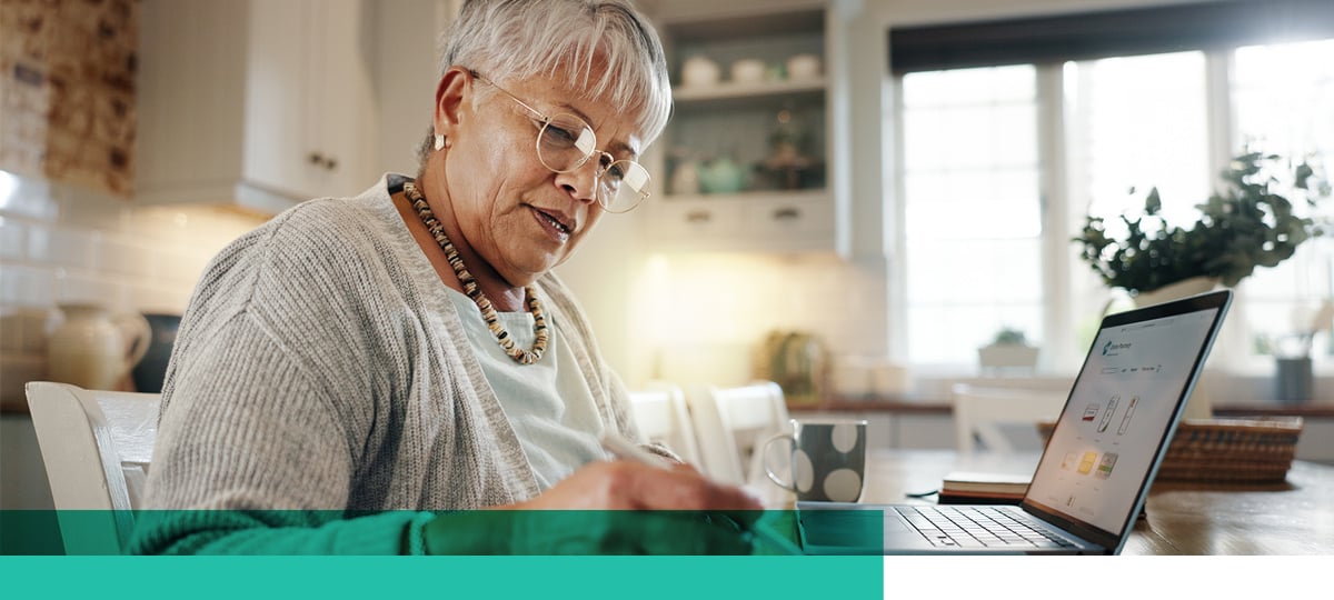 Woman reviewing life insurance online using a laptop.